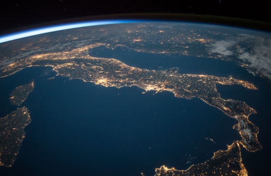 Satelite view of Earth at night, focus on Italy